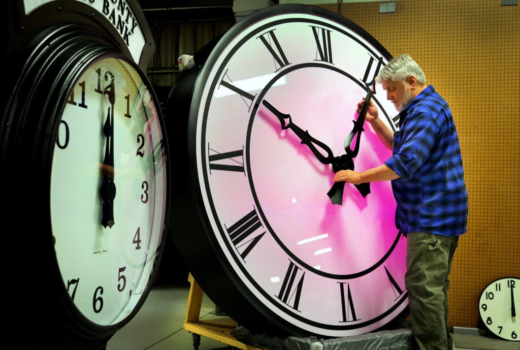 A clock being adjusted for Daylight Savings Time